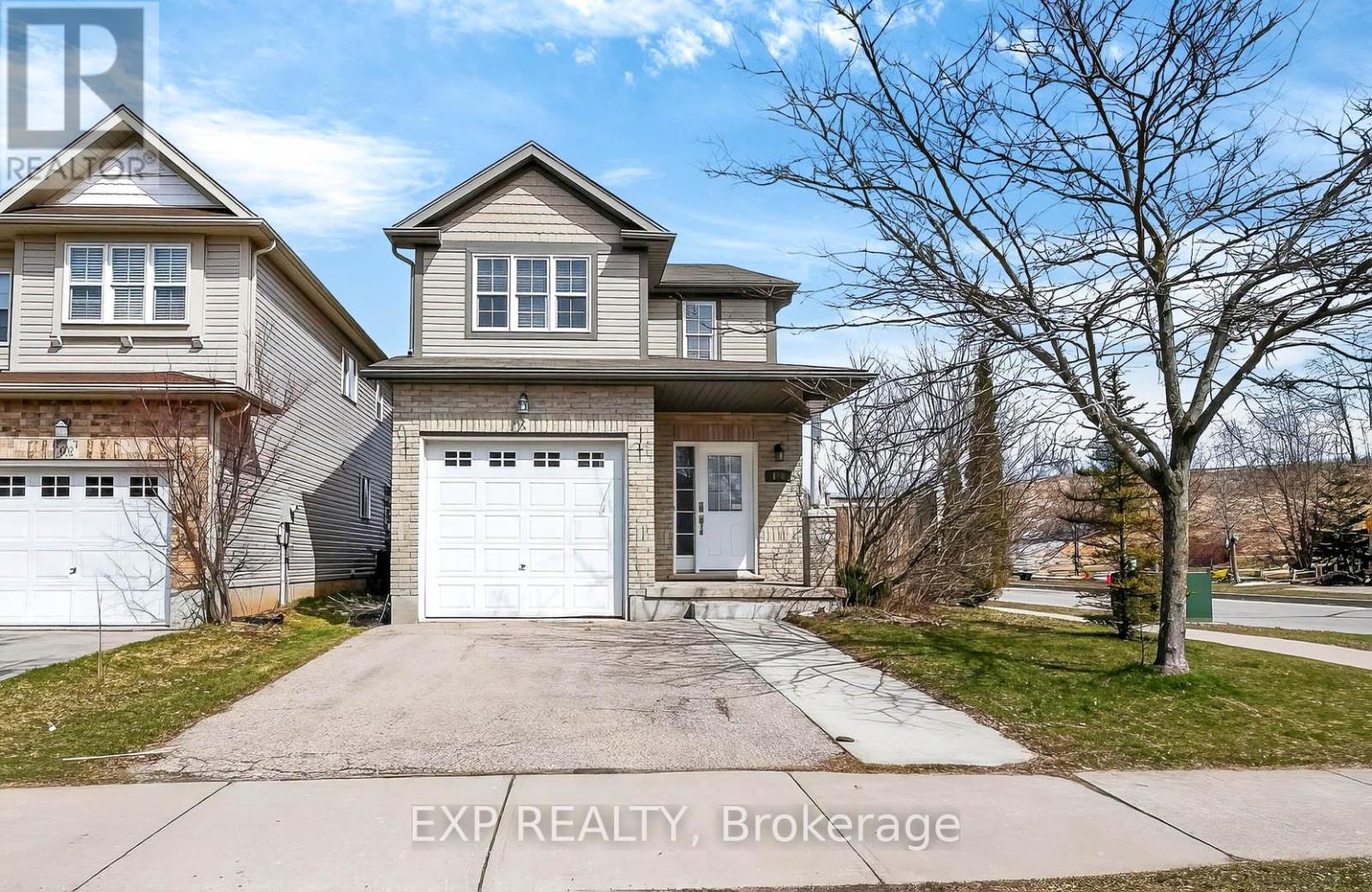 A two-story house with a garage is for sale.
