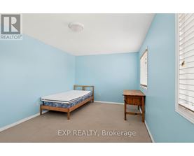 A bedroom with a bed and a desk.