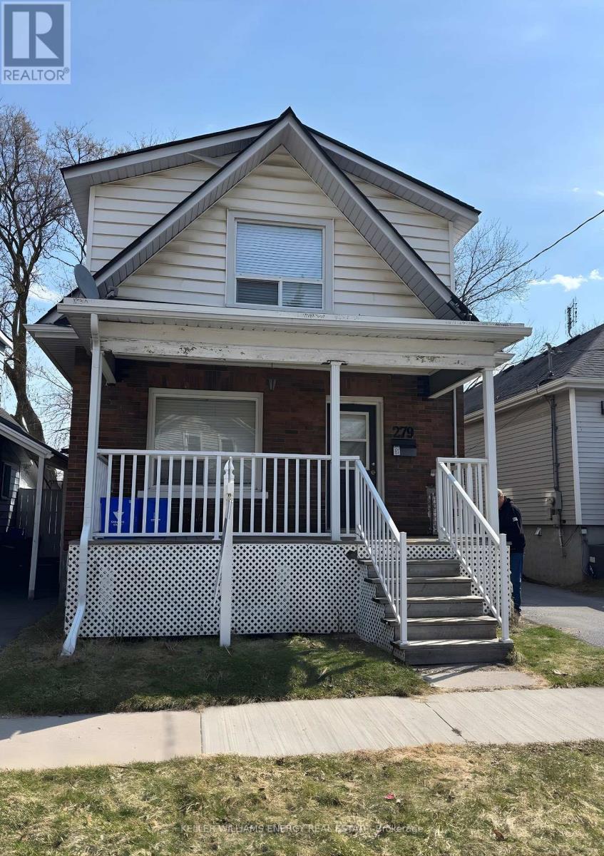 A house with a porch and a white fence.