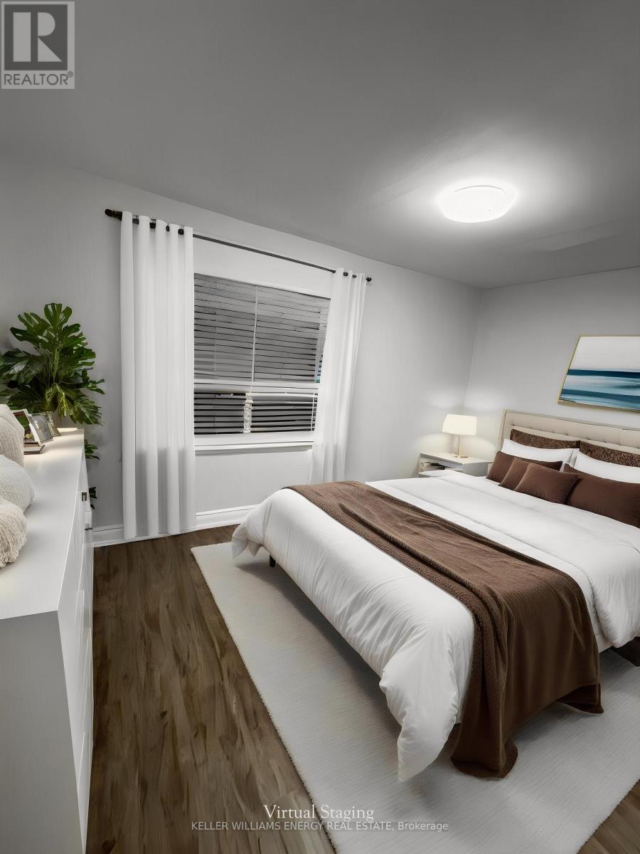 A bedroom with a large bed and a plant on the side table.