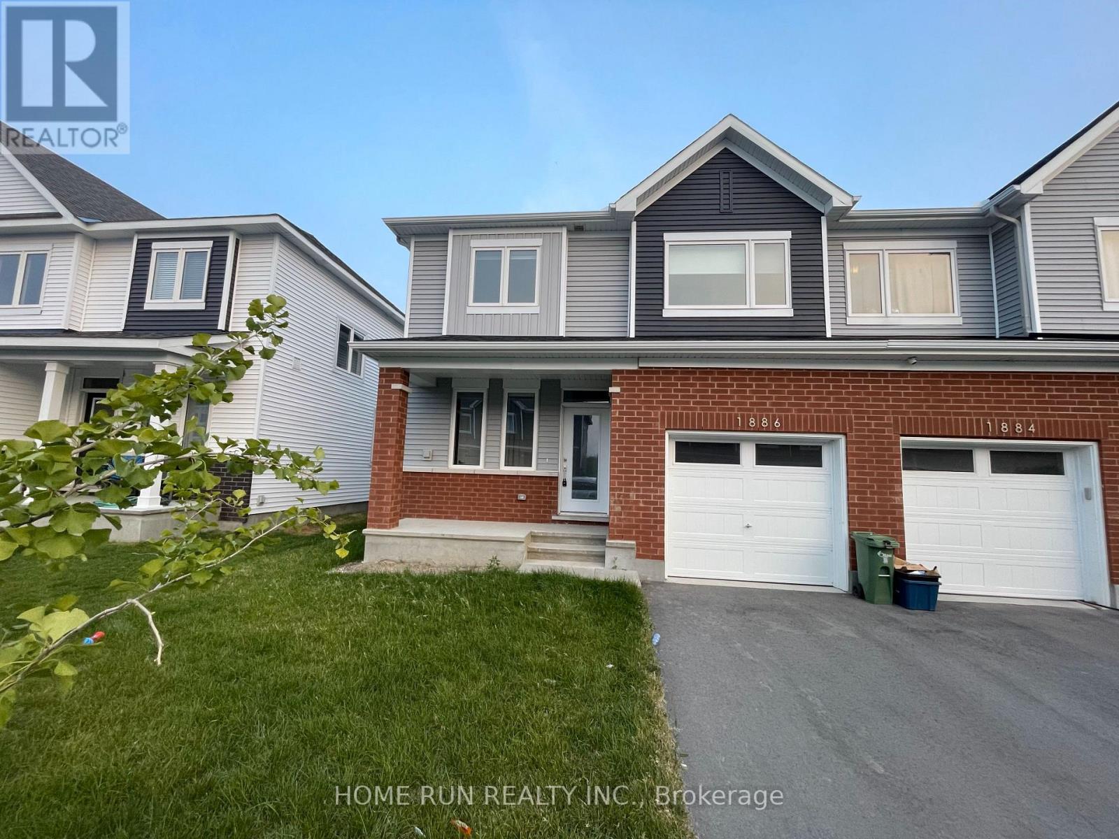 A two-story house with a garage is for sale.