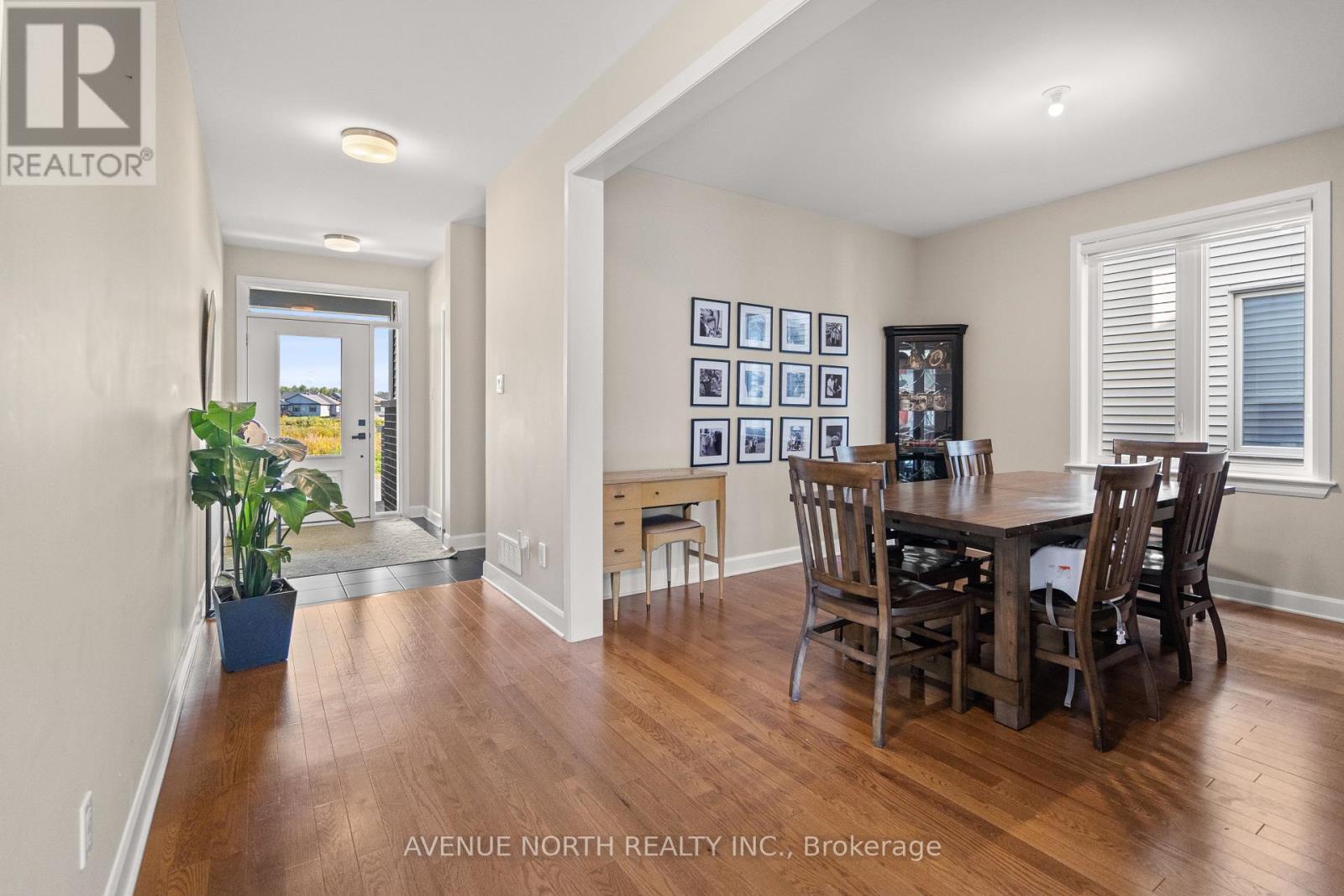 A dining room with a table set for four.