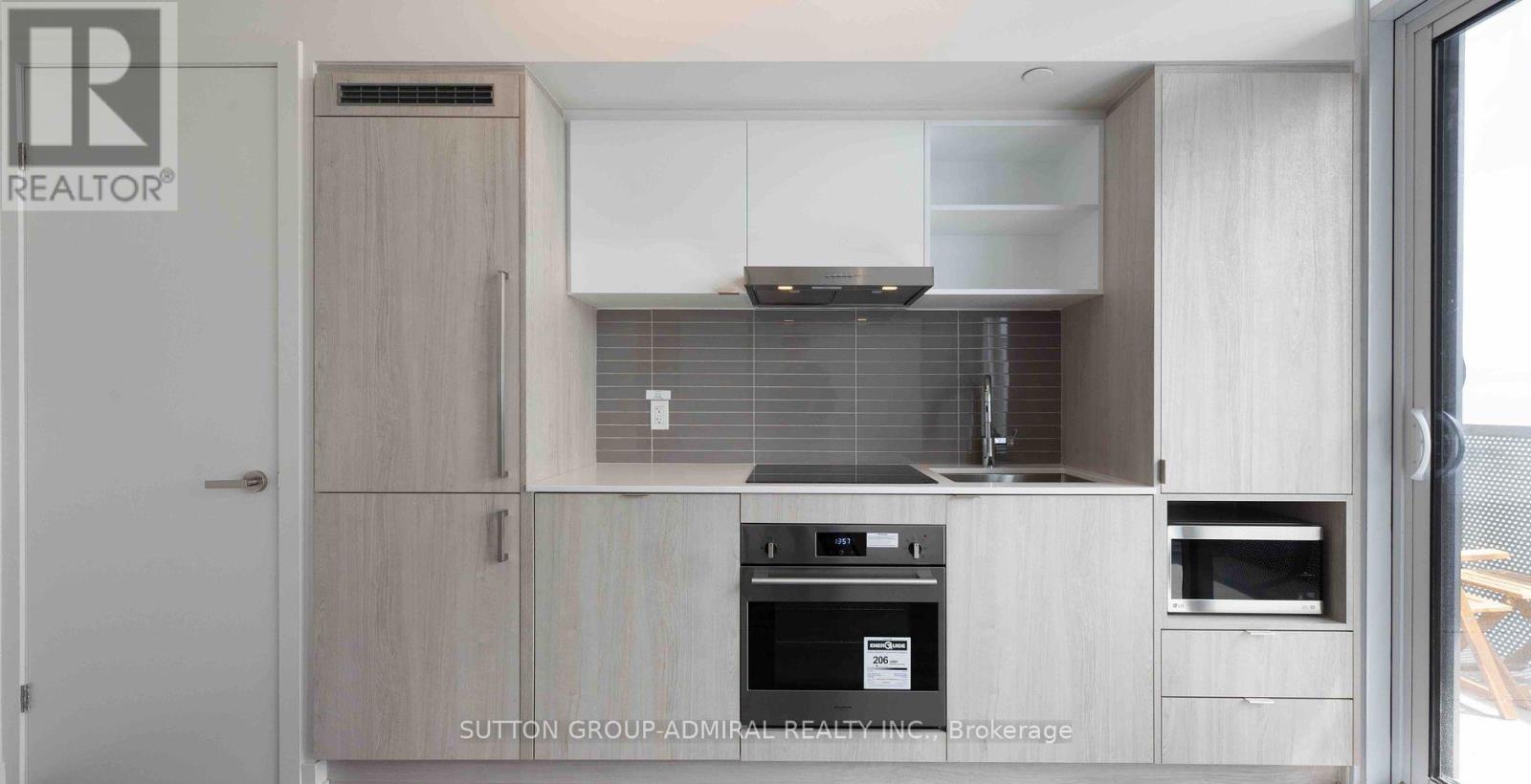 A modern kitchen with a stove top oven and a microwave.