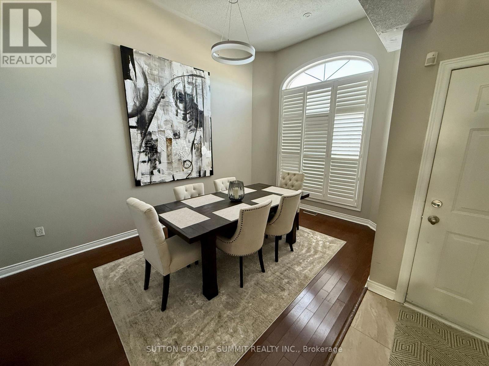 A dining room with a table and chairs.