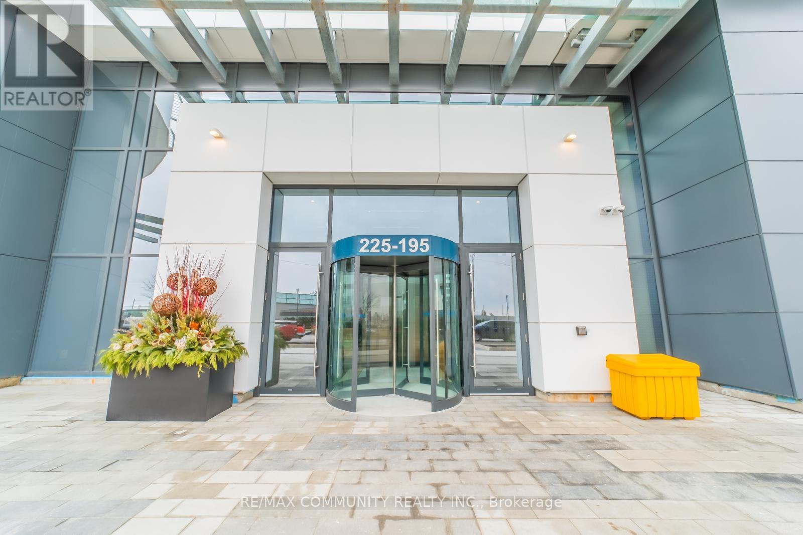 The entrance to a building with a glass door and a sign that reads "225-195".