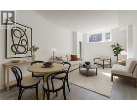 A modern dining room with a round table and chairs.