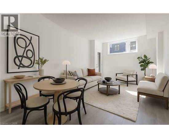 A modern dining room with a round table and chairs.
