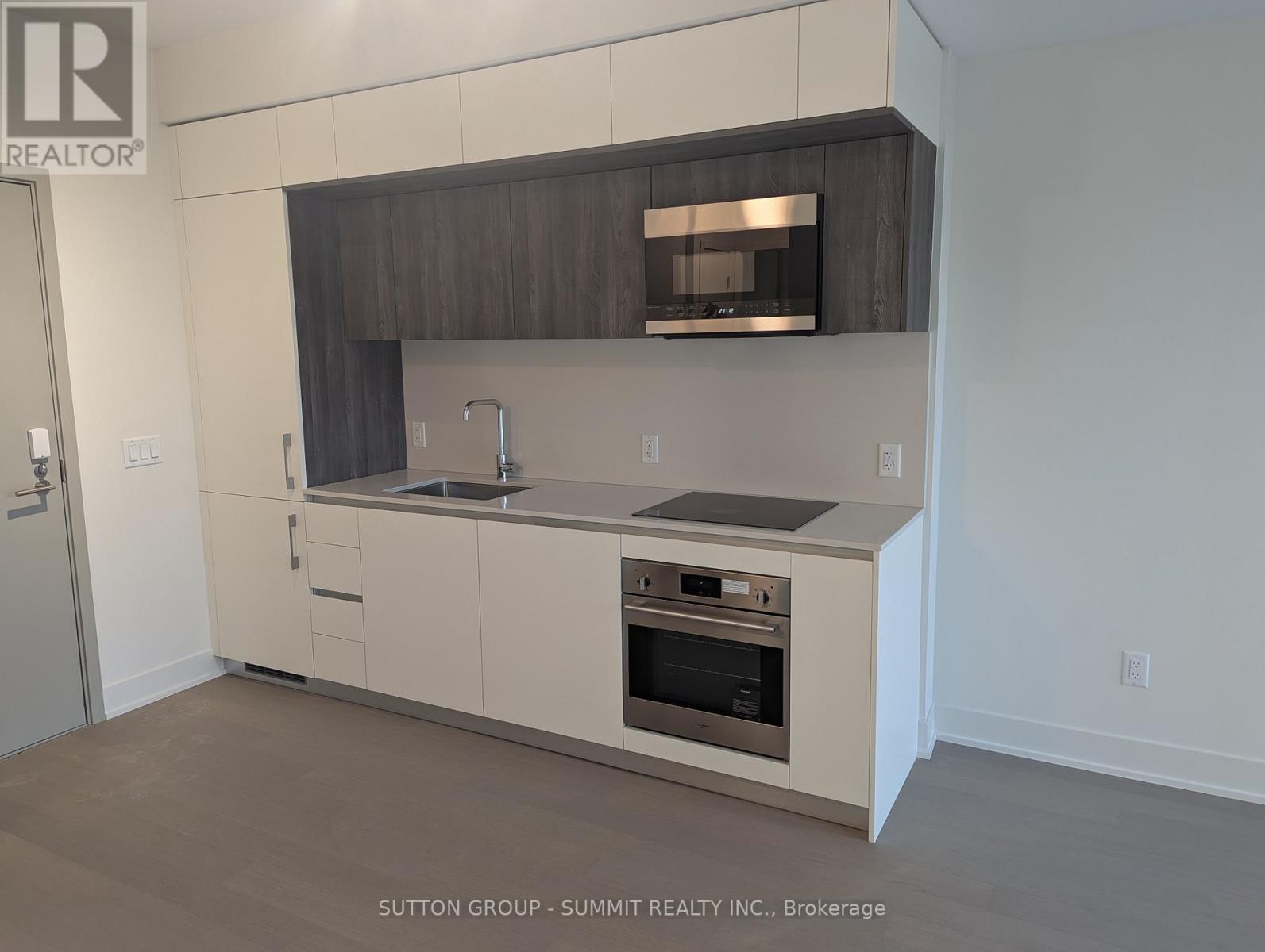A modern kitchen with a stainless steel oven and a microwave above the stove.