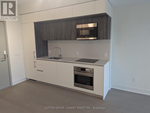 A modern kitchen with a stainless steel oven and a microwave above the stove.