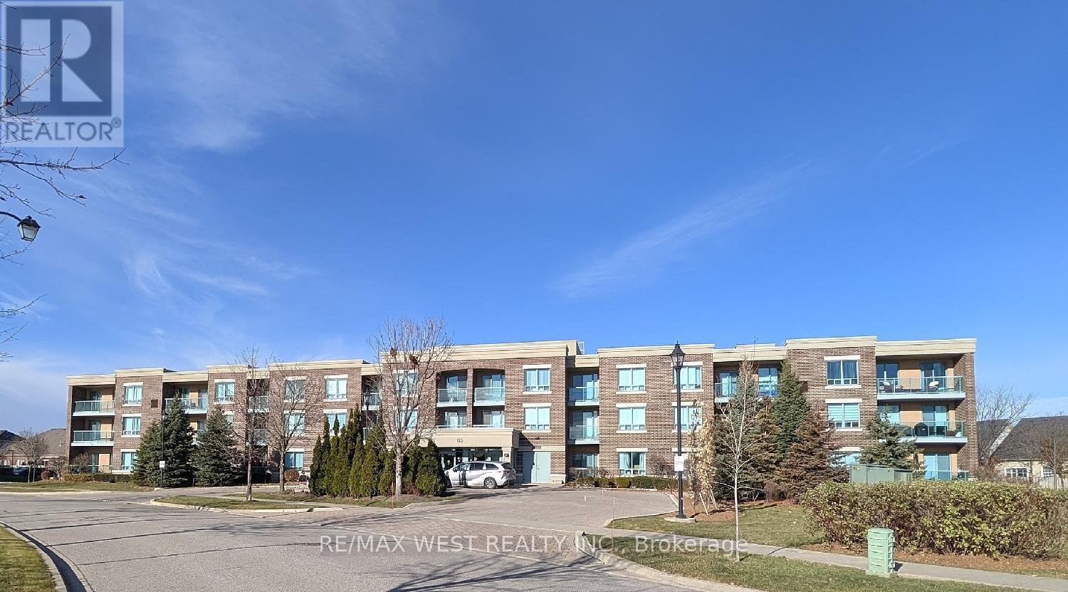 A large apartment complex with multiple buildings and a parking lot in front.
