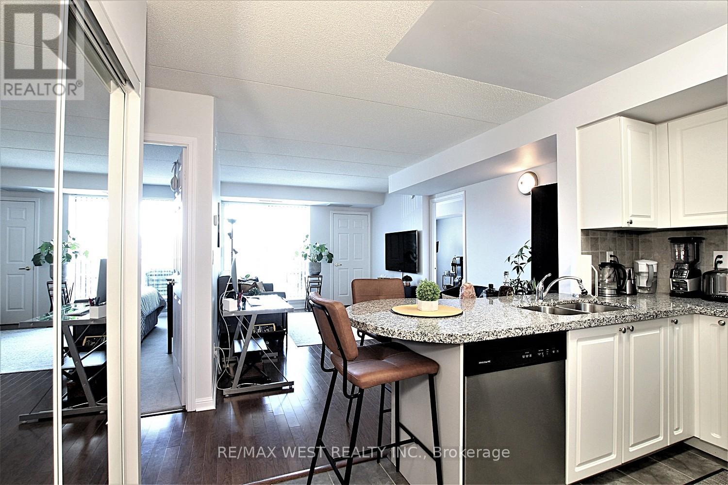 A kitchen with white cabinets and a granite countertop.