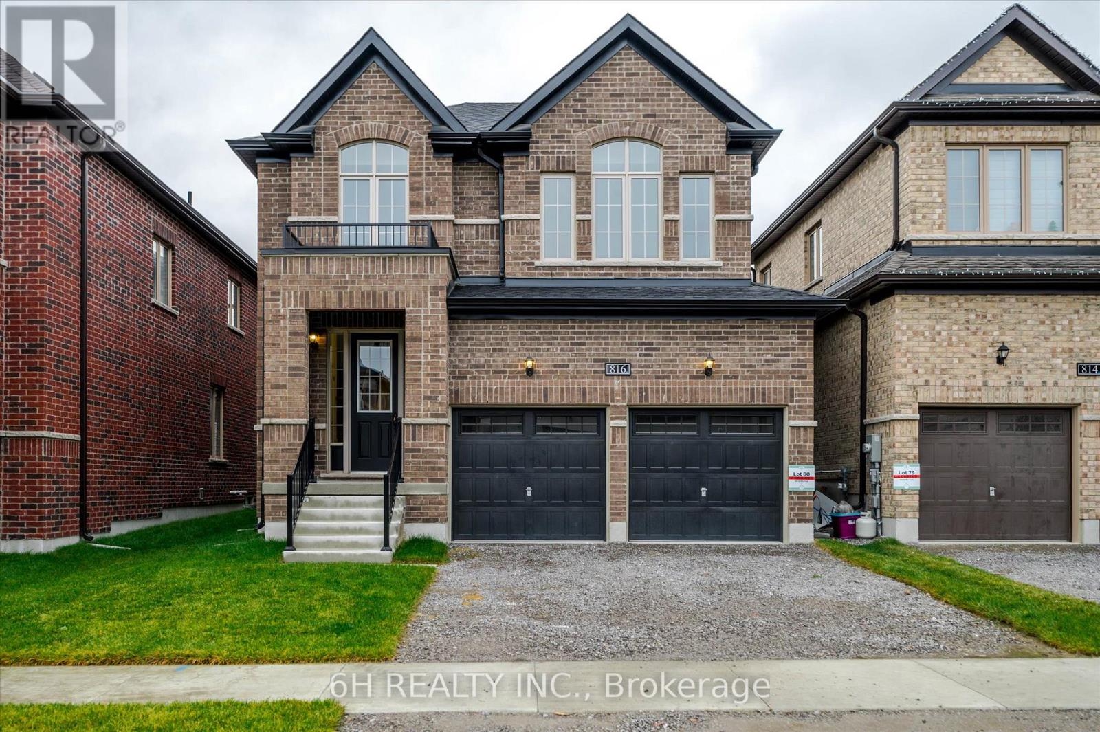 A large brick house with a garage is for sale.