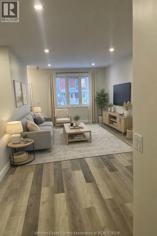 A living room with a grey couch and a wooden coffee table.
