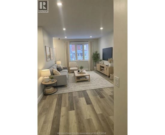 A living room with a grey couch and a wooden coffee table.