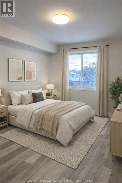 A well-lit bedroom with a large bed and a view of the outside through the window.