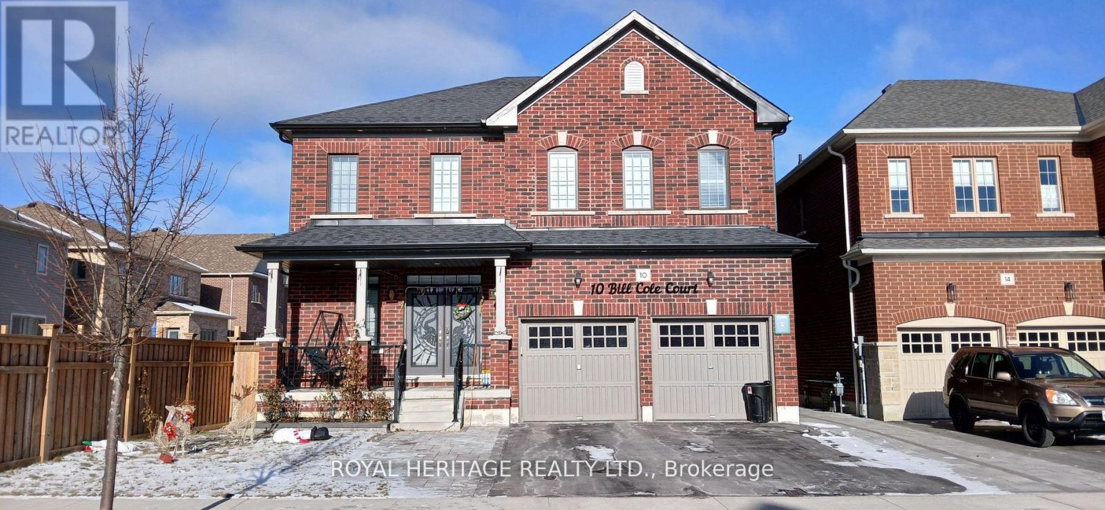 A house with a sign that says "Royal Heritage Realty Ltd., Brokerage" in front of it.