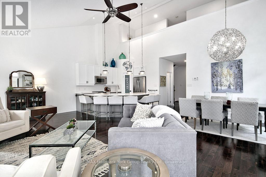 A modern living room with a glass table and white furniture.