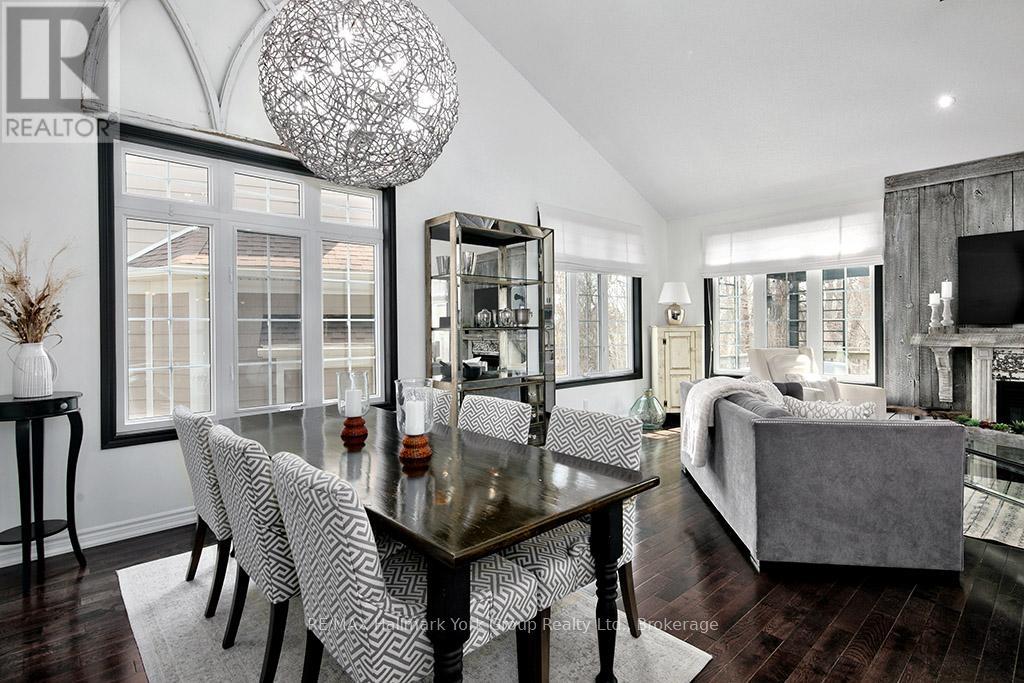 A modern dining room with a glass table and chairs.