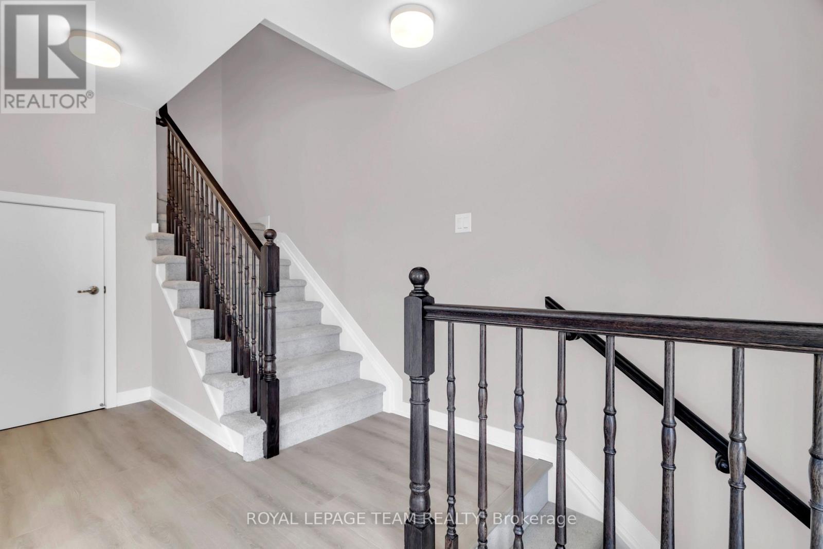 A staircase with a black railing and white steps.
