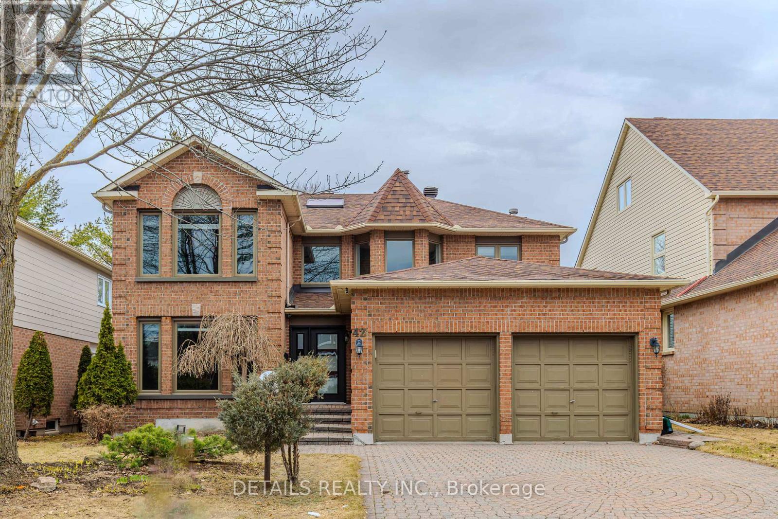 A house with a brick facade and a large driveway.