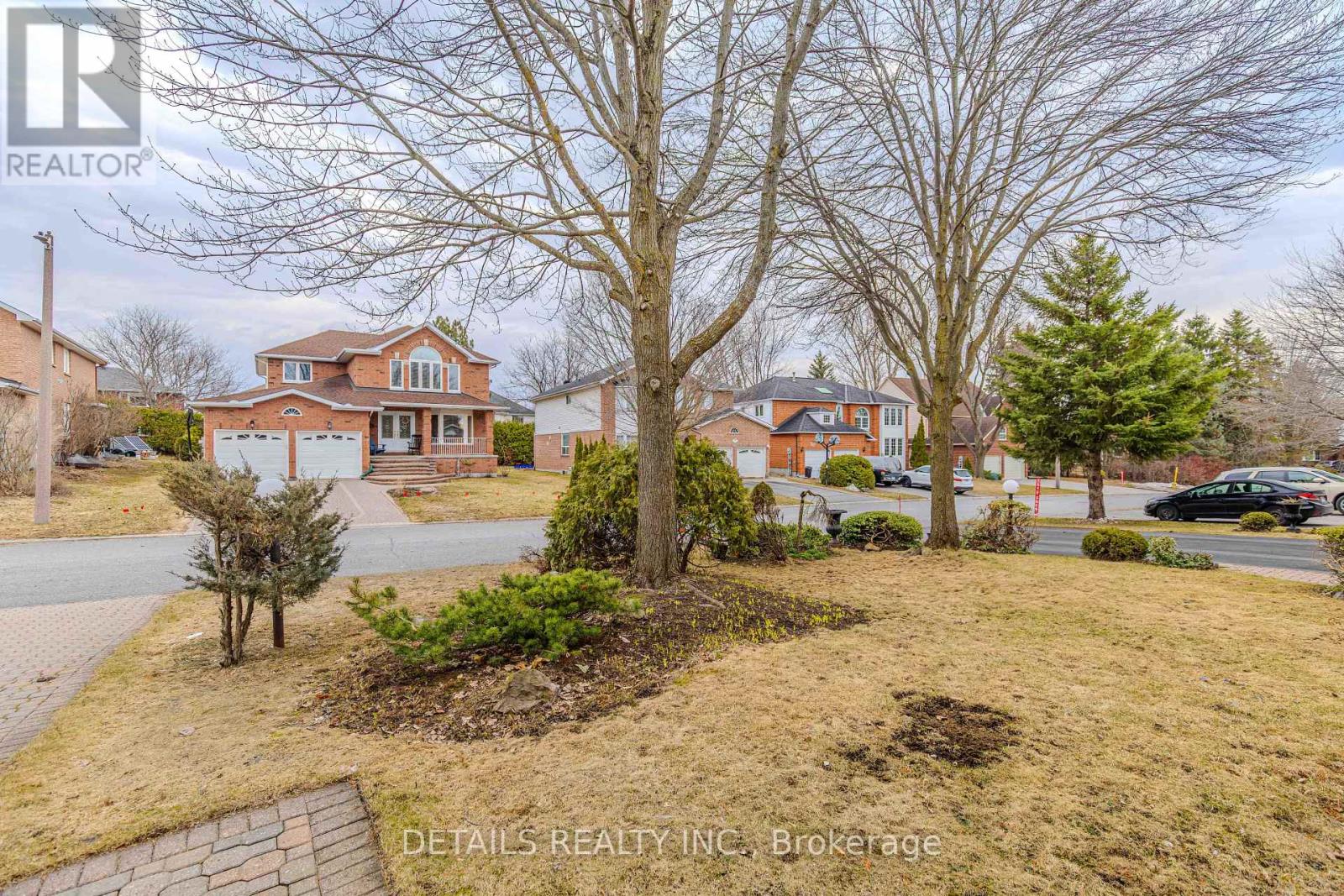 A realtor photo of a house with a tree in front.