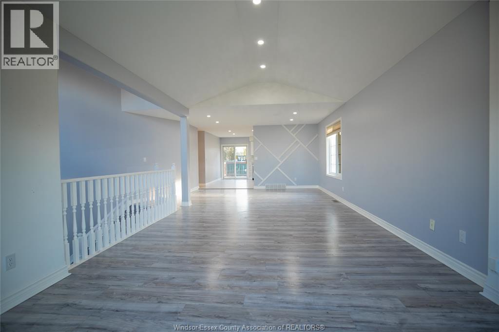 A long hallway with a balcony on the left side.