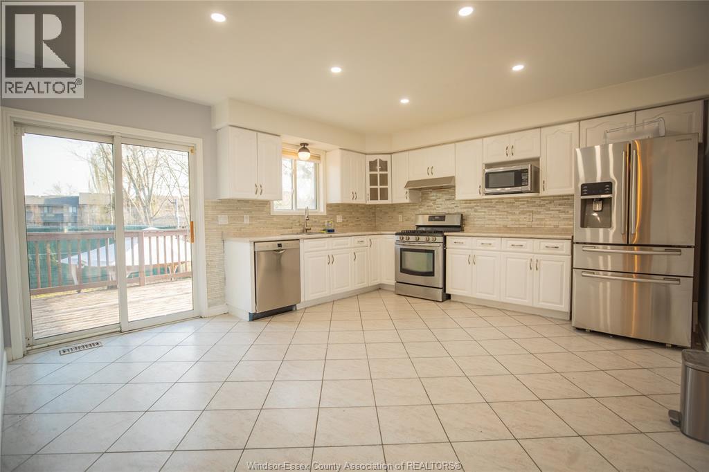 A kitchen with white cabinets and appliances is on the market.