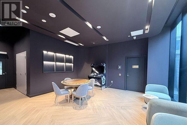 A modern living room with a dining table and chairs.