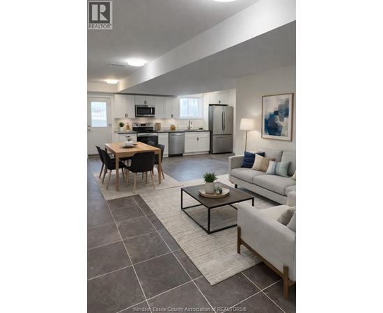A modern kitchen with a dining table and a couch.