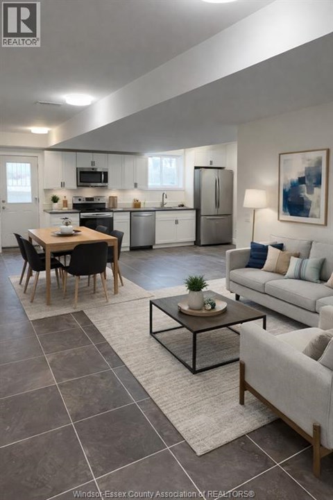 A modern kitchen with a dining table and a couch.
