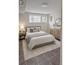 A bedroom with a bed, nightstand, and a mirror.