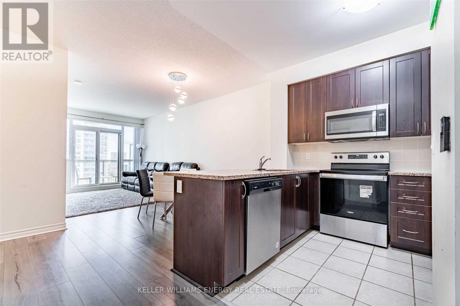 A kitchen with a dining table and chairs is shown.
