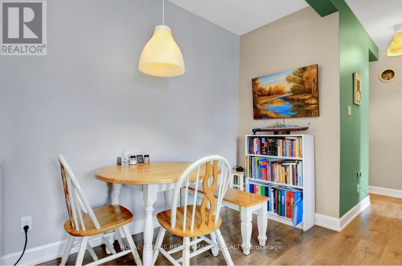 A dining room with a table and chairs.
