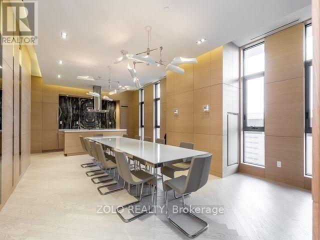 A dining room with a long table and chairs.
