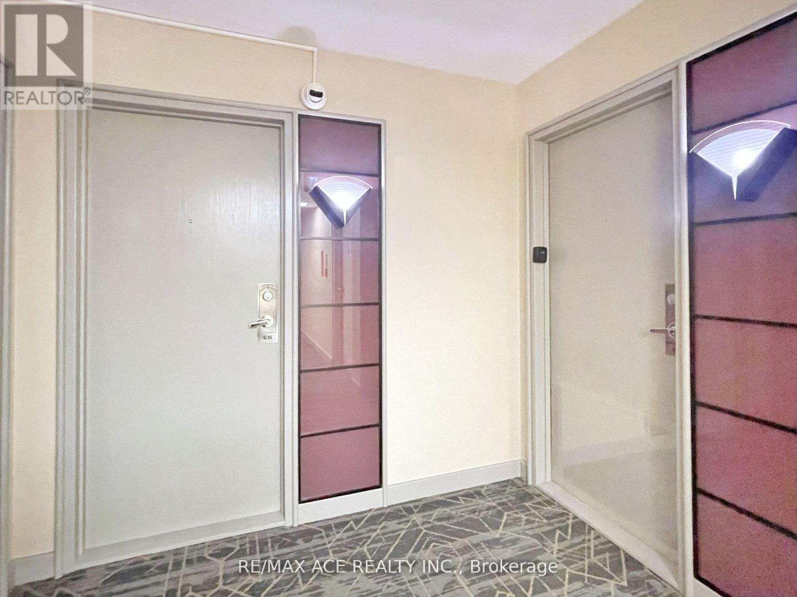 A hallway with a door on the left and a glass door on the right.