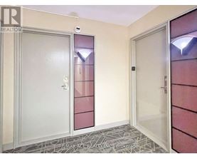 A hallway with a door on the left and a glass door on the right.