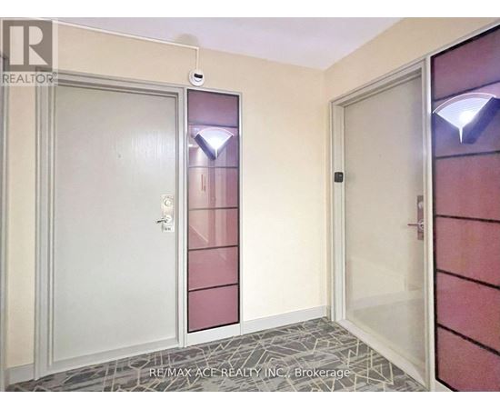 A hallway with a door on the left and a glass door on the right.