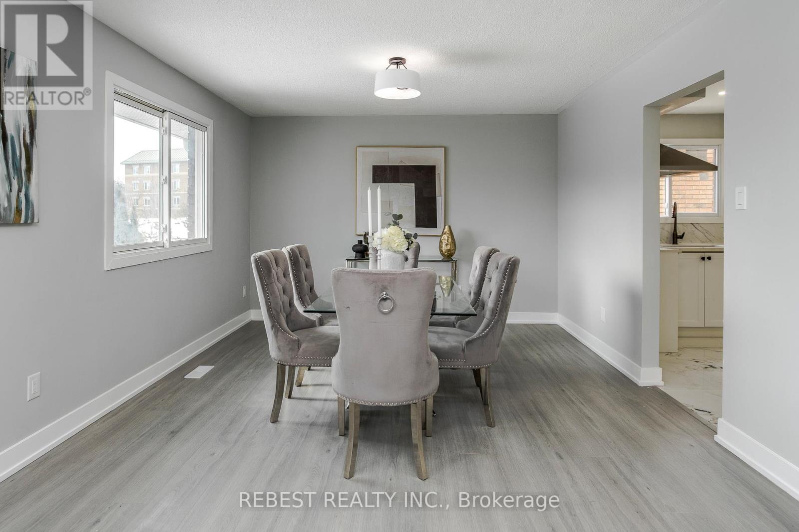 A dining room with a table and chairs.