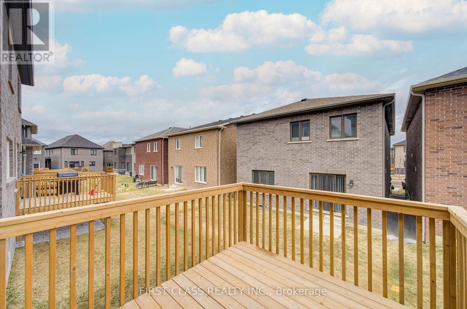 A wooden deck overlooks a row of houses.