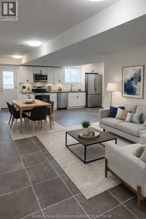 A modern kitchen with a dining table and a couch.