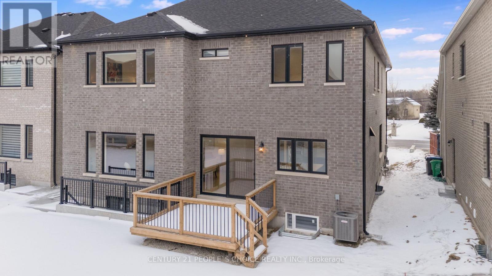 A brick building with a wooden deck in the snow.