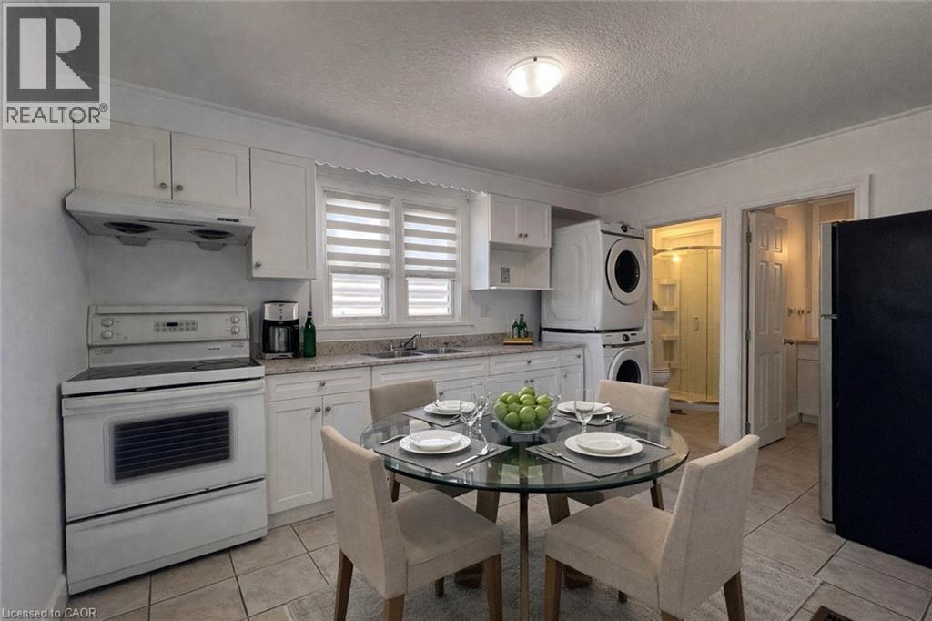 A well-lit kitchen with a dining table set for two.