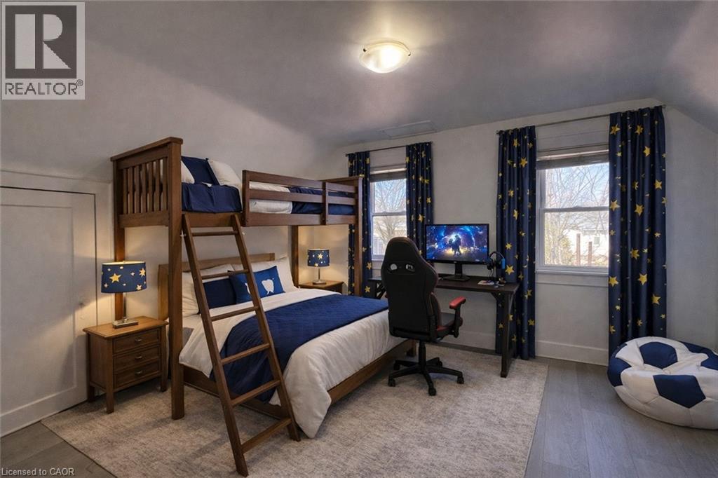 A bedroom with a bunk bed and a desk with a chair.