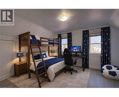 A bedroom with a bunk bed and a desk with a chair.