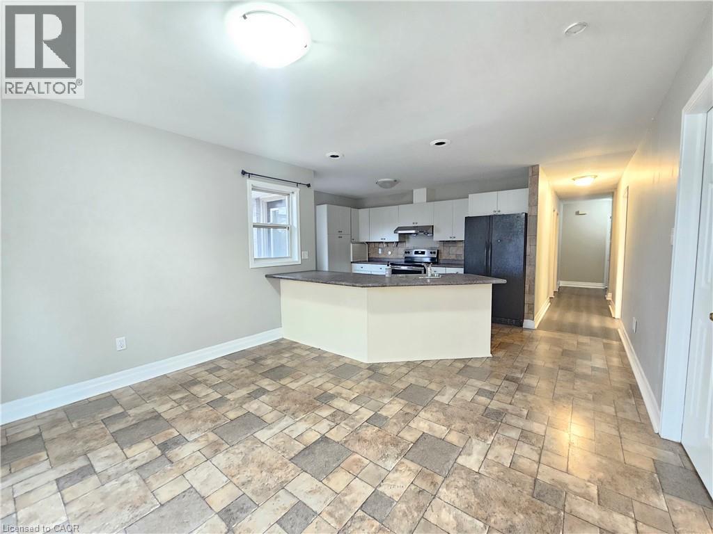 A kitchen area with a tiled floor and a countertop.