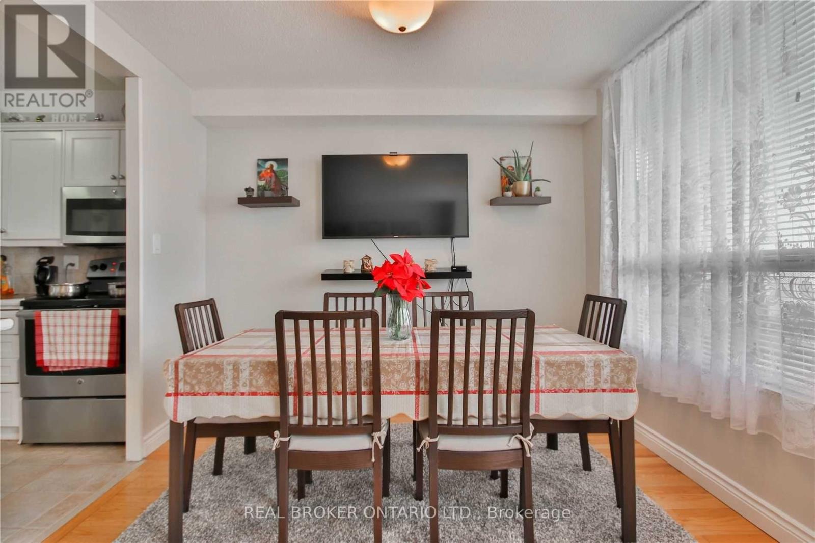 A dining room with a table set for four.