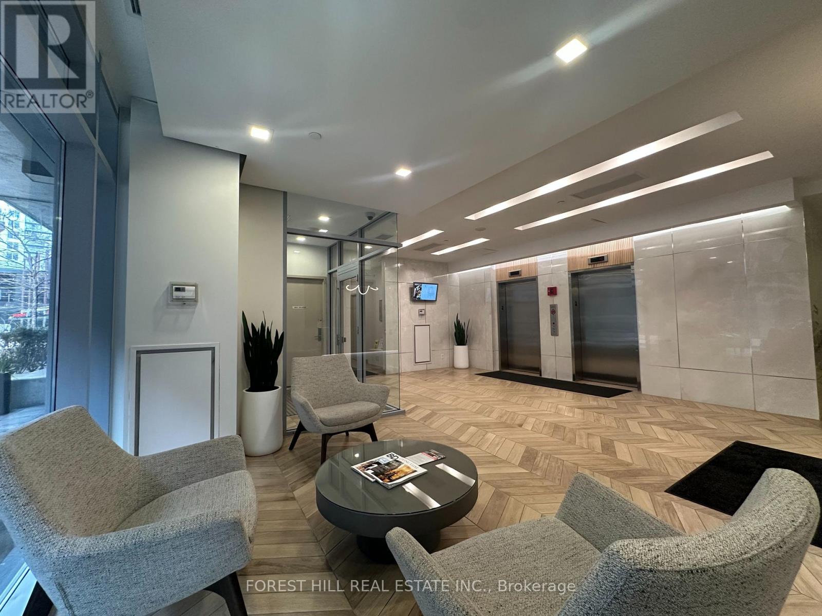 A brokerage office with a glass wall and a wooden floor.