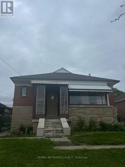A house with a brown door and a small porch.