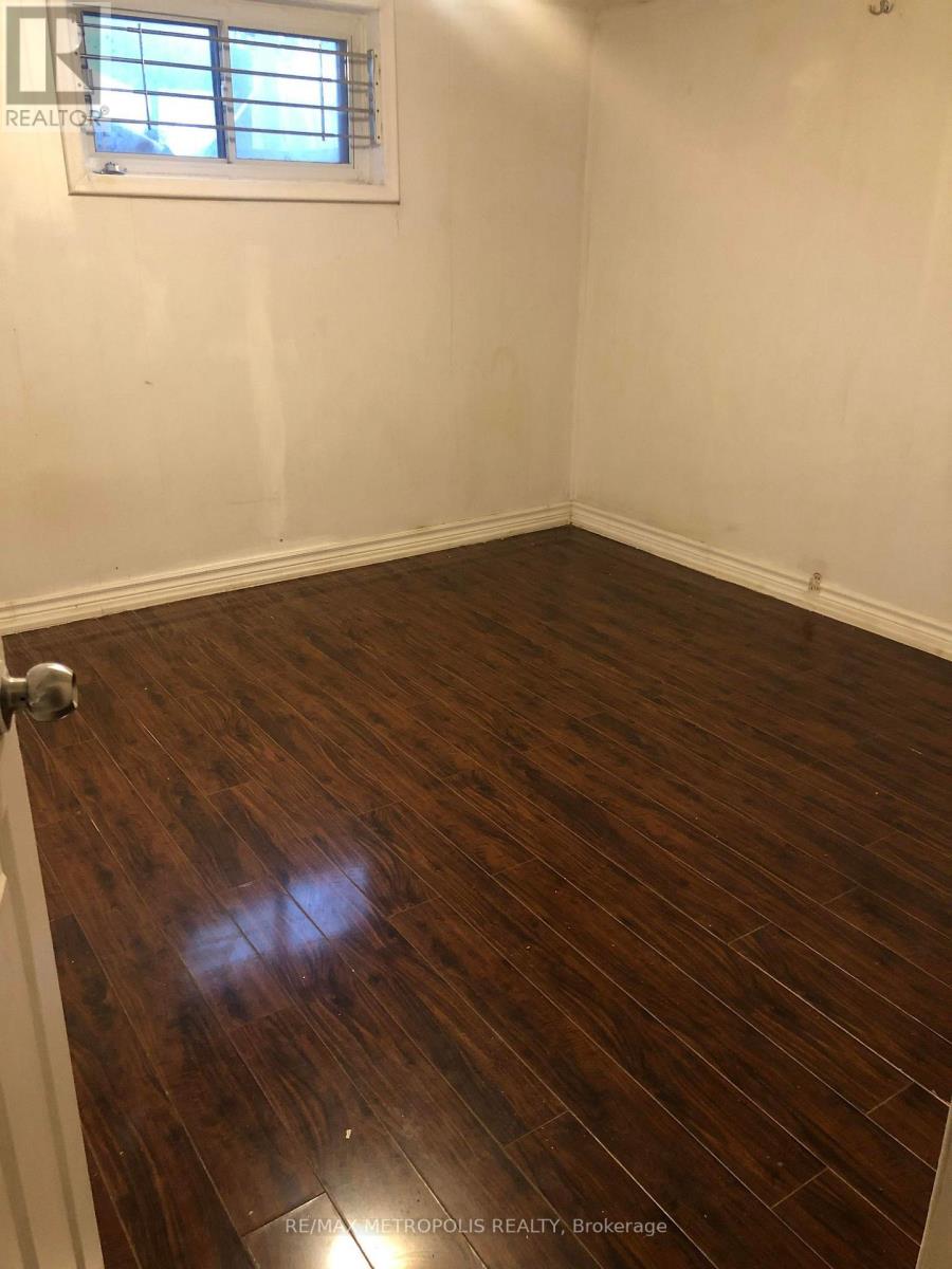 A room with a wooden floor and a window.