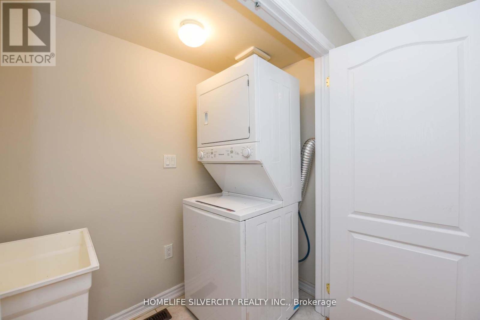 A white cabinet with a white toilet and a white sink in a bathroom.